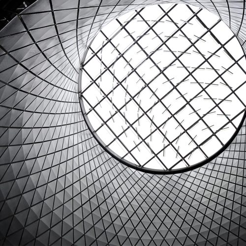 Worm's eye view of a futuristic geometric skylight showcasing modern architecture.