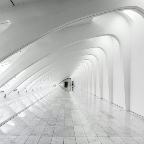 Explore the sweeping modern arches and minimalistic design of the Milwaukee Art Museum's white hallway.